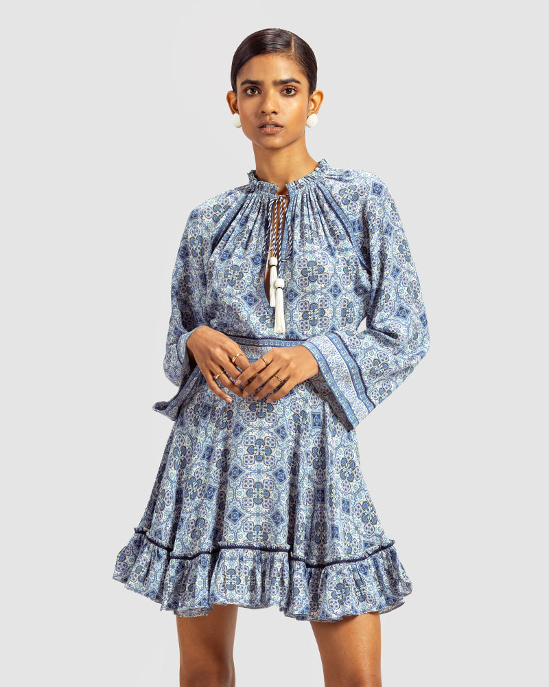 Blue Marissa Print Ruffled Silk DressProduct DescriptionThis print patchwork ruffled dress is a mix of fit and flare, making it a perfect summer dress. It features a V-shaped neckline, a tasselled drawsDressesBlue Marissa Print Ruffled Silk Dress