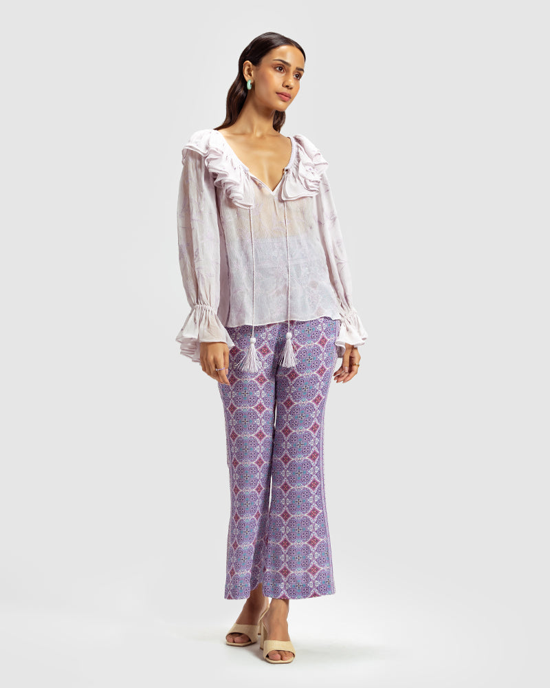 Lilac Ruffled Silk Blouse With Dori EmbroideryProduct DescriptionThis statement crinkled silk chiffon blouse features Dori embroidery and floral motifs inspired by Mughal architecture. Details include elasticateTopsLilac Ruffled Silk Blouse