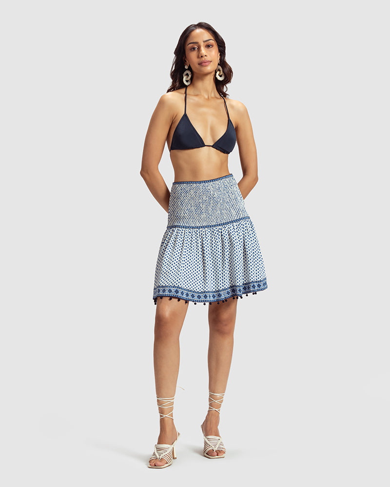 Tara Print Silk Crepe Minka SkirtProduct DescriptionMade from silk crepe, this skirt features our exquisite blue print inspired by folk geometric patterns. Details include smocking on the front and SkirtsTara Print Silk Crepe Minka Skirt