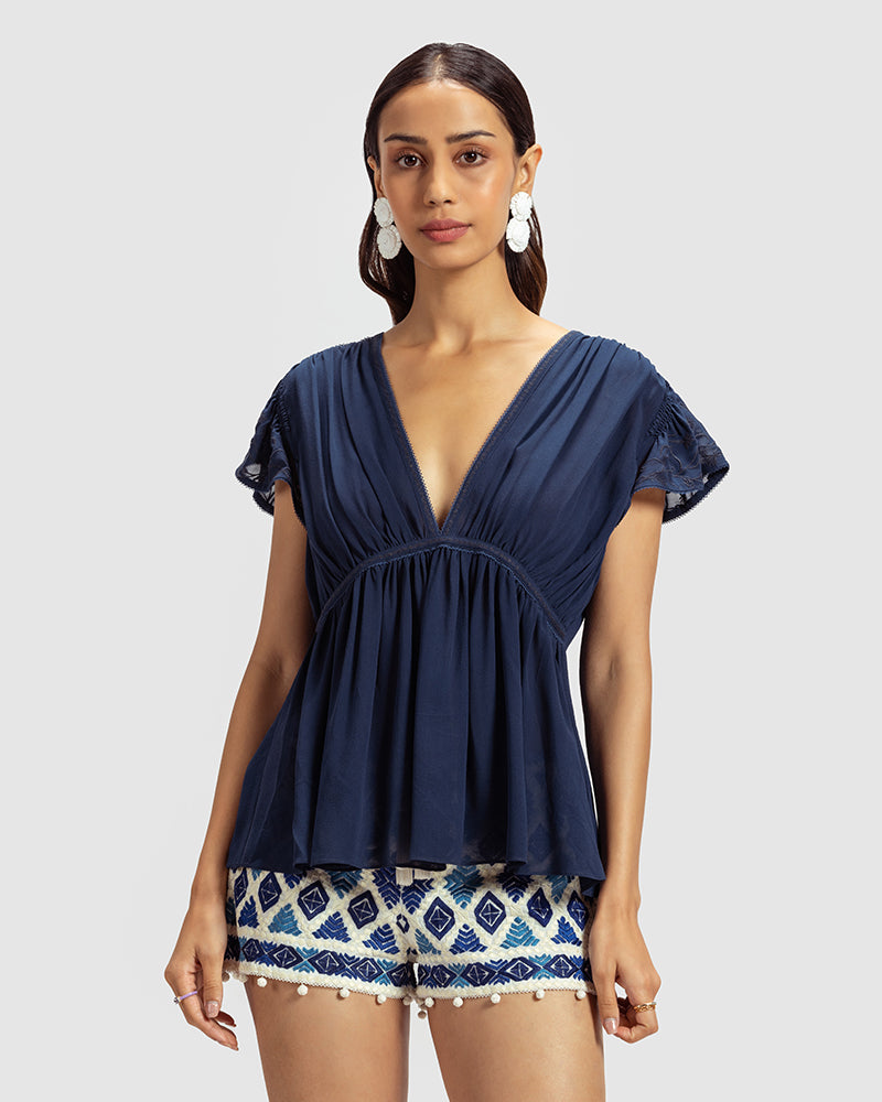 Blue Gathered Silk Georgette TopProduct DescriptionMade from 100% silk georgette, this top features hand-guided machine embroidery inspired by floral motifs. Details include a V-shaped neckline, smTopsBlue Gathered Silk Georgette Top