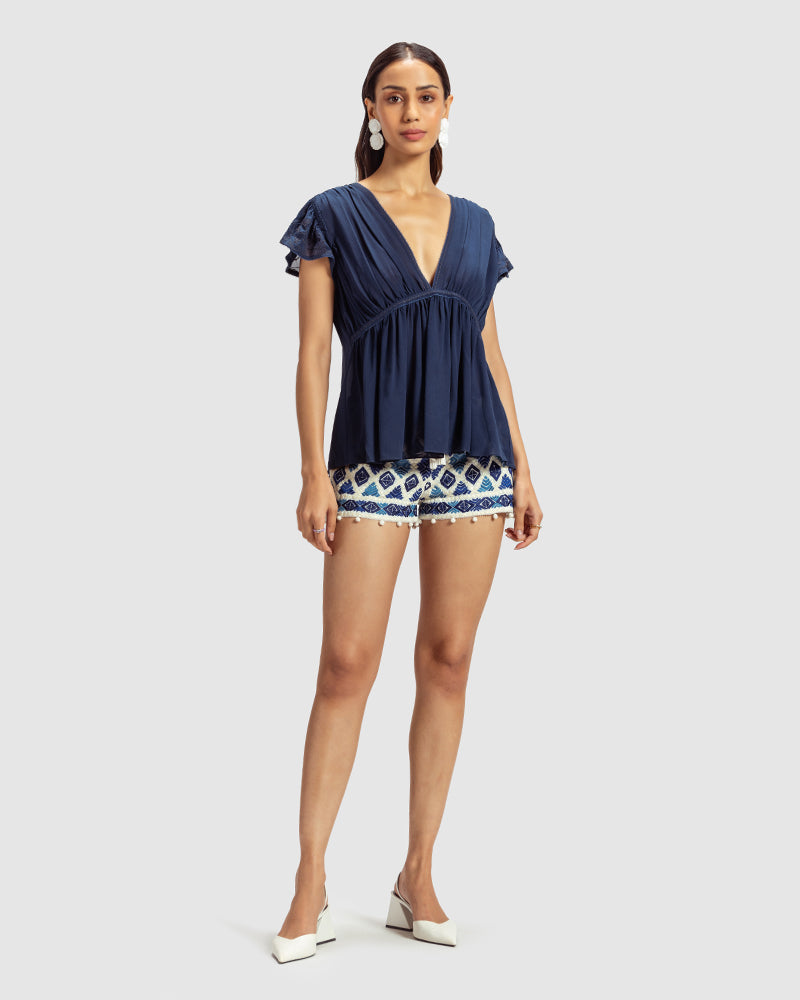 Blue Gathered Silk Georgette TopProduct DescriptionMade from 100% silk georgette, this top features hand-guided machine embroidery inspired by floral motifs. Details include a V-shaped neckline, smTopsBlue Gathered Silk Georgette Top