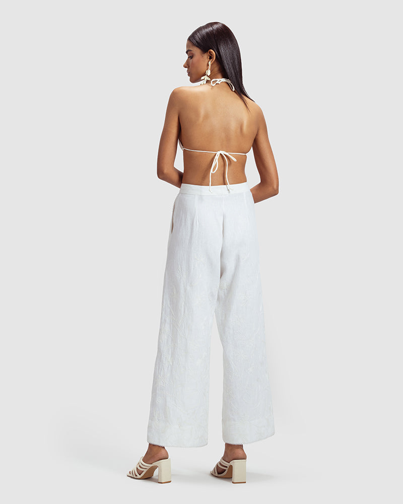 White Linen Palazzo Pant With Dori EmbroideryProduct DescriptionOur flared linen palazzo includes Dori embroidery all over and a delicate touch of lace at the hem. It also features a hook-and-eye zipper closurePantsWhite Linen Palazzo Pant