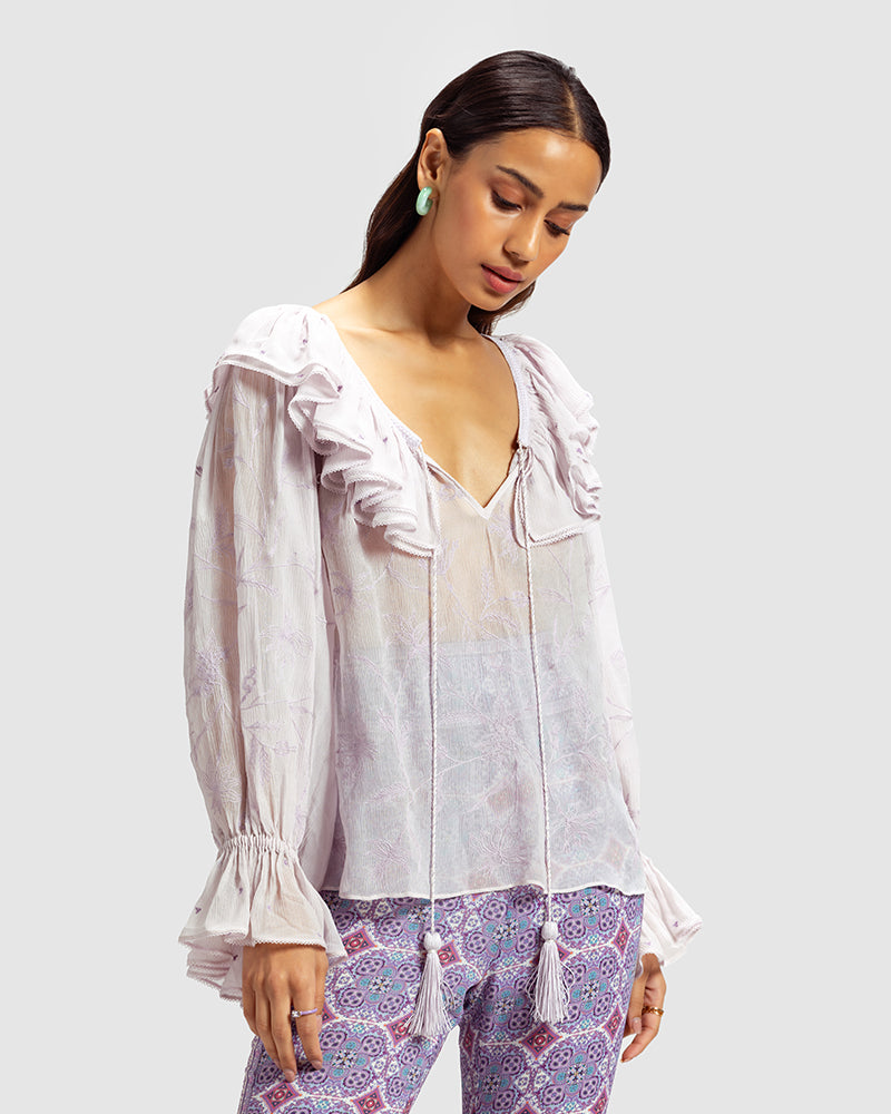 Lilac Ruffled Silk Blouse With Dori EmbroideryProduct DescriptionThis statement crinkled silk chiffon blouse features Dori embroidery and floral motifs inspired by Mughal architecture. Details include elasticateTopsLilac Ruffled Silk Blouse