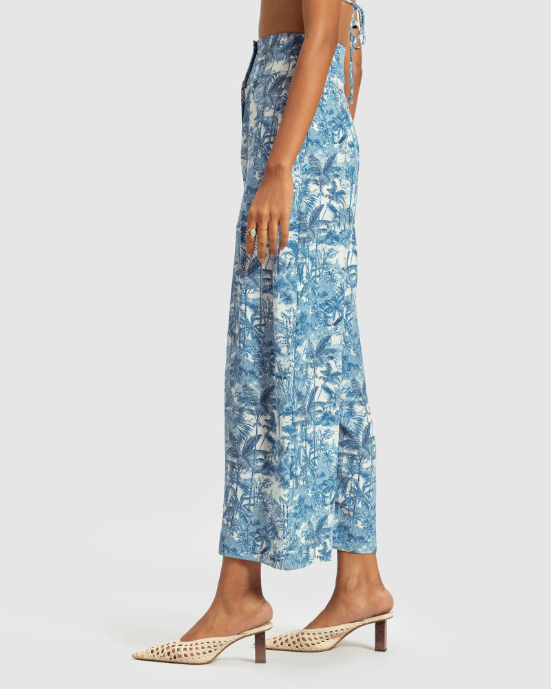 Blue Tropical Print Silk Pleated PantProduct DescriptionMade from silk satin, these high-waisted pleated pants feature our statement tropical print that reimagines Indian flora and fauna motifs with conPantsBlue Tropical Print Silk Pleated Pant
