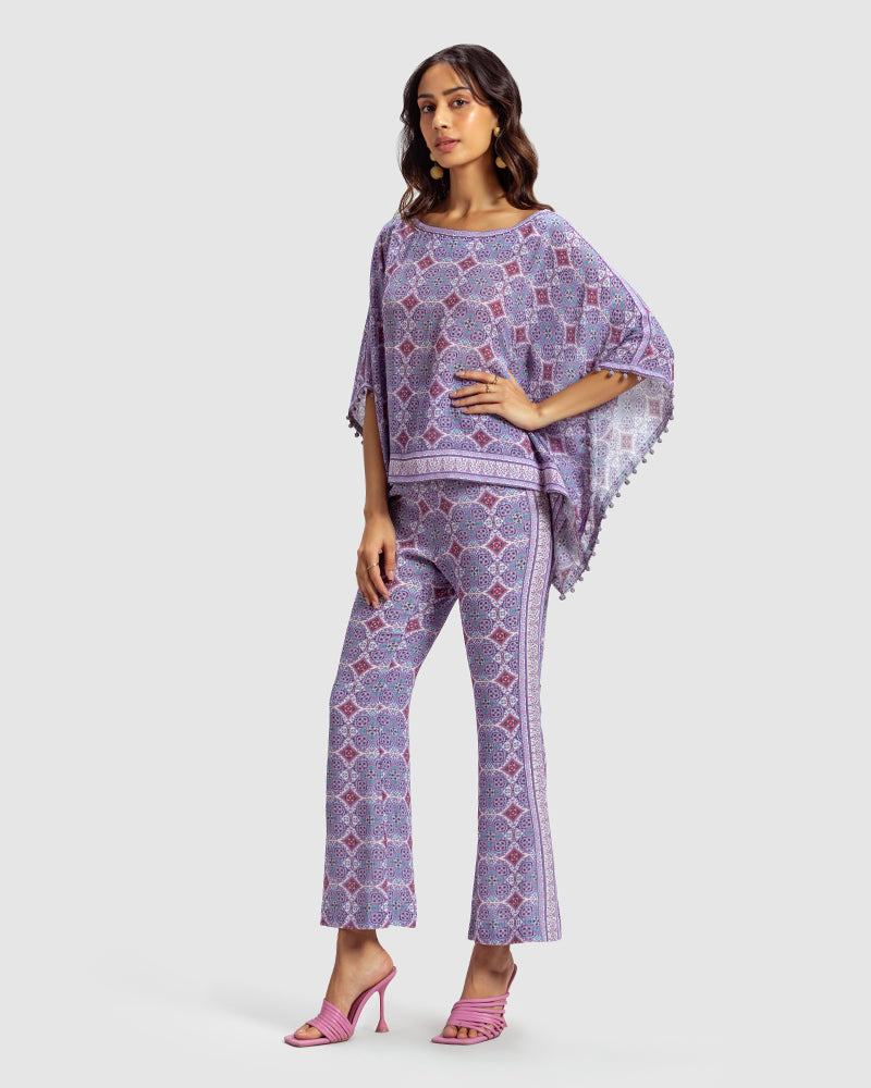 Lavender Marissa Print Silk Poncho TopProduct DescriptionMade from silk crepe, this boatneck poncho top features our modern geometric print patchwork. Comes in a relaxed fit and also features bobble trimTopsLavender Marissa Print Silk Poncho Top