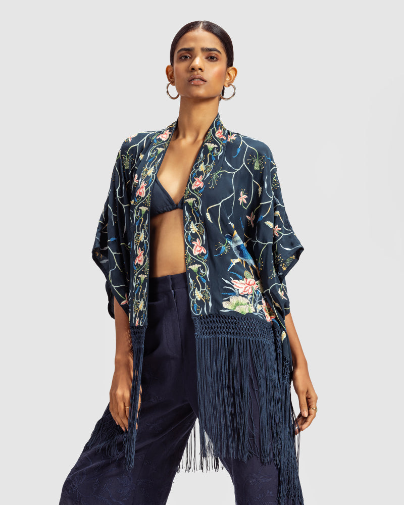 Navy Parsi Gara Embroidered ShrugProduct DescriptionTraditionally seen on Parsi saris, this luxurious silk crepe shrug is adorned with multicoloured Parsi Gara hand embroidery. It also features a geShrugsNavy Parsi Gara Embroidered Shrug