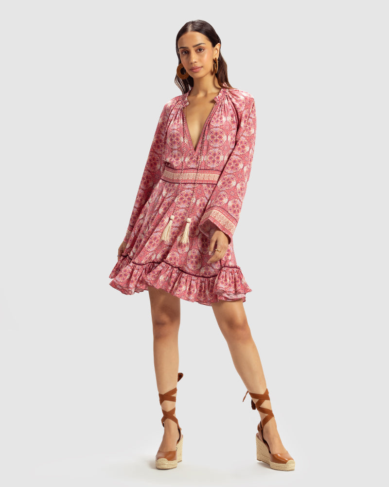 Pink Marissa Print Ruffled Silk DressProduct DescriptionThis print patchwork ruffled dress is a mix of fit and flare, making it a perfect summer dress. It features a V-shaped neckline, a tasselled drawsDressesPink Marissa Print Ruffled Silk Dress