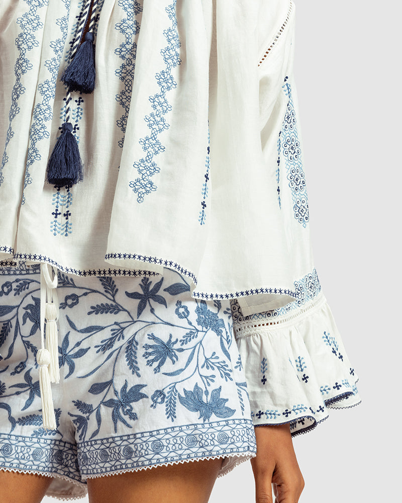 Blue on White Embroidered Linen Blend Boho TopProduct DescriptionThis linen blend boho top features an eclectic blend of blue-on-white lace and embroidery with Kolam-inspired motifs. Comes in an oversized relaxeTopsWhite Embroidered Linen Blend Boho Top