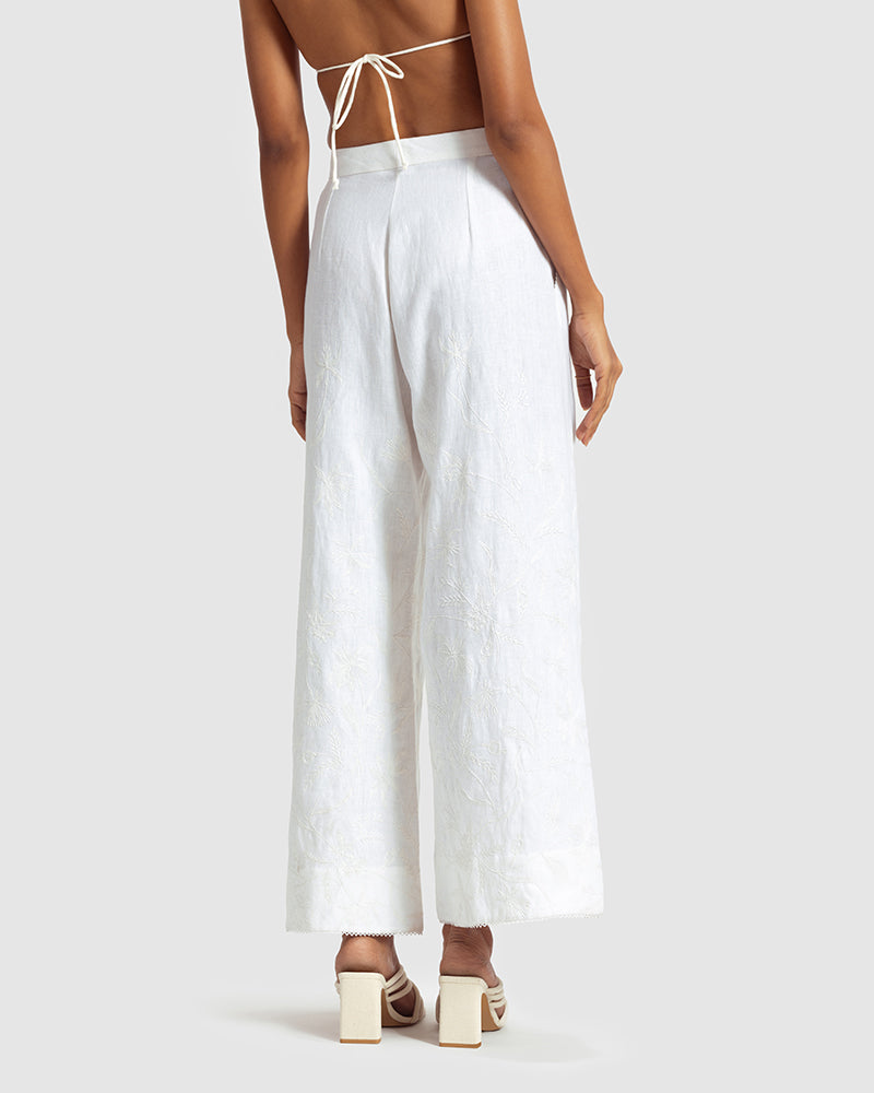 White Linen Palazzo Pant With Dori EmbroideryProduct DescriptionOur flared linen palazzo includes Dori embroidery all over and a delicate touch of lace at the hem. It also features a hook-and-eye zipper closurePantsWhite Linen Palazzo Pant