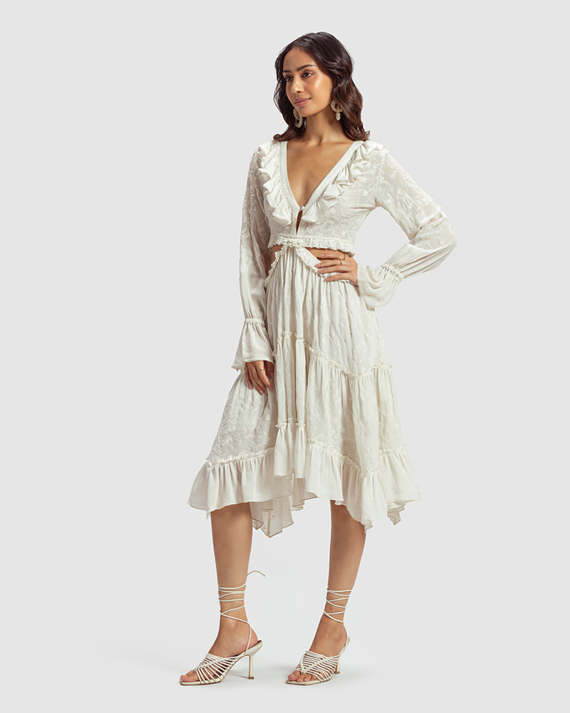 White Embroidered Cutout Silk Georgette DressProduct DescriptionOur silk georgette dress features a prominent cut-out waist, a ruffled neckline, and hand-guided machine embroidery inspired by floral motifs. DetDressesWhite Embroidered Cutout Silk Georgette Dress