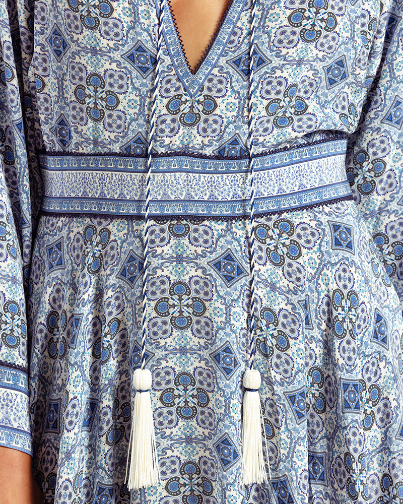 Blue Marissa Print Ruffled Silk DressProduct DescriptionThis print patchwork ruffled dress is a mix of fit and flare, making it a perfect summer dress. It features a V-shaped neckline, a tasselled drawsDressesBlue Marissa Print Ruffled Silk Dress