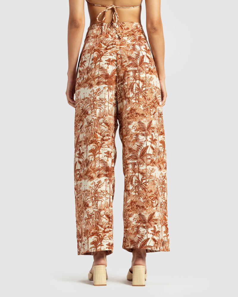 Brown Tropical Print Silk Pleated PantProduct DescriptionMade from silk satin, these high-waisted pleated pants feature our statement tropical print that reimagines Indian flora and fauna motifs with conPantsBrown Tropical Print Silk Pleated Pant