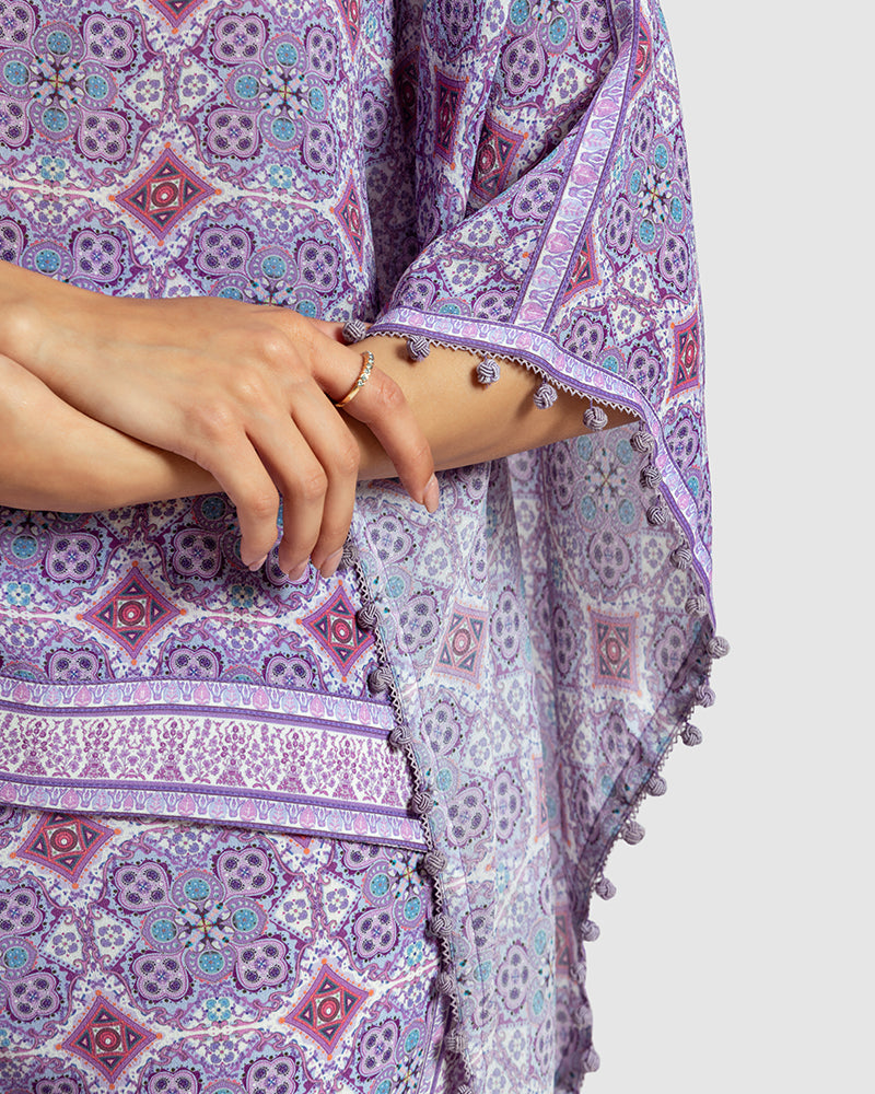 Lavender Marissa Print Silk Poncho TopProduct DescriptionMade from silk crepe, this boatneck poncho top features our modern geometric print patchwork. Comes in a relaxed fit and also features bobble trimTopsLavender Marissa Print Silk Poncho Top