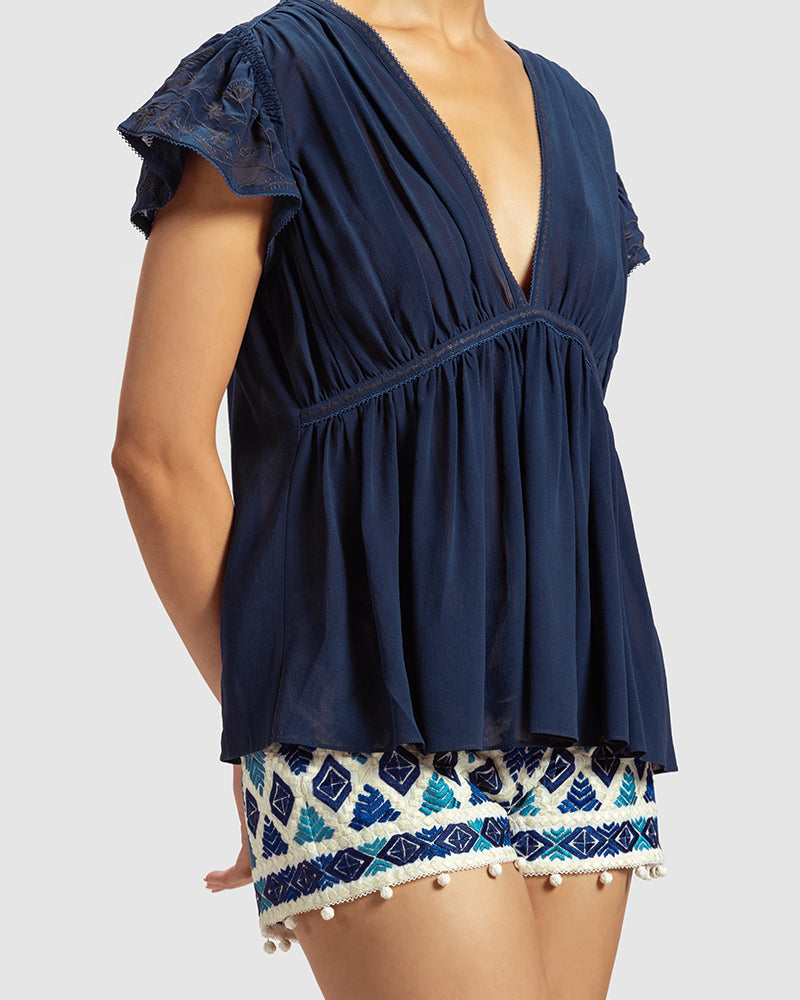 Blue Gathered Silk Georgette TopProduct DescriptionMade from 100% silk georgette, this top features hand-guided machine embroidery inspired by floral motifs. Details include a V-shaped neckline, smTopsBlue Gathered Silk Georgette Top