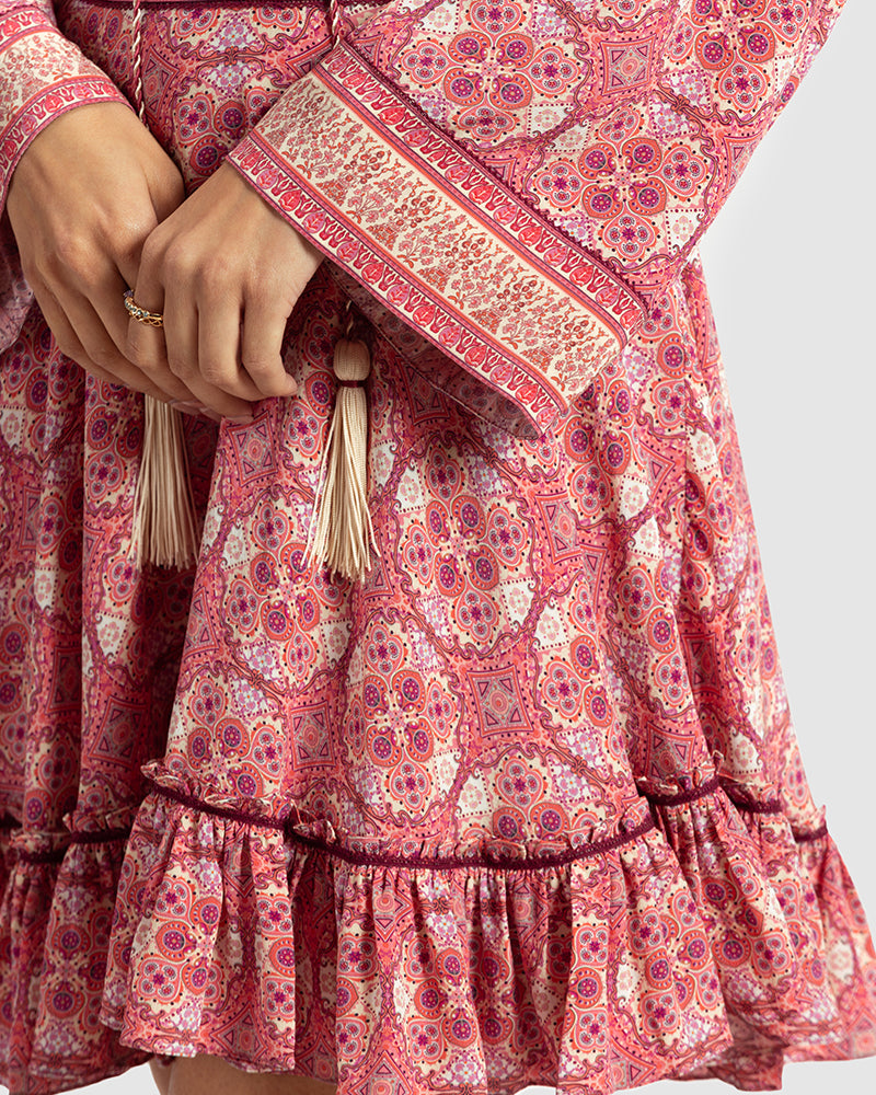 Pink Marissa Print Ruffled Silk DressProduct DescriptionThis print patchwork ruffled dress is a mix of fit and flare, making it a perfect summer dress. It features a V-shaped neckline, a tasselled drawsDressesPink Marissa Print Ruffled Silk Dress
