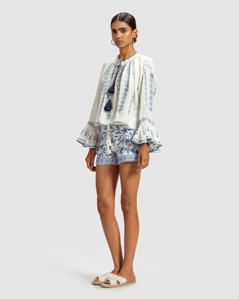 Blue on White Embroidered Linen Blend Boho TopProduct DescriptionThis linen blend boho top features an eclectic blend of blue-on-white lace and embroidery with Kolam-inspired motifs. Comes in an oversized relaxeTopsWhite Embroidered Linen Blend Boho Top