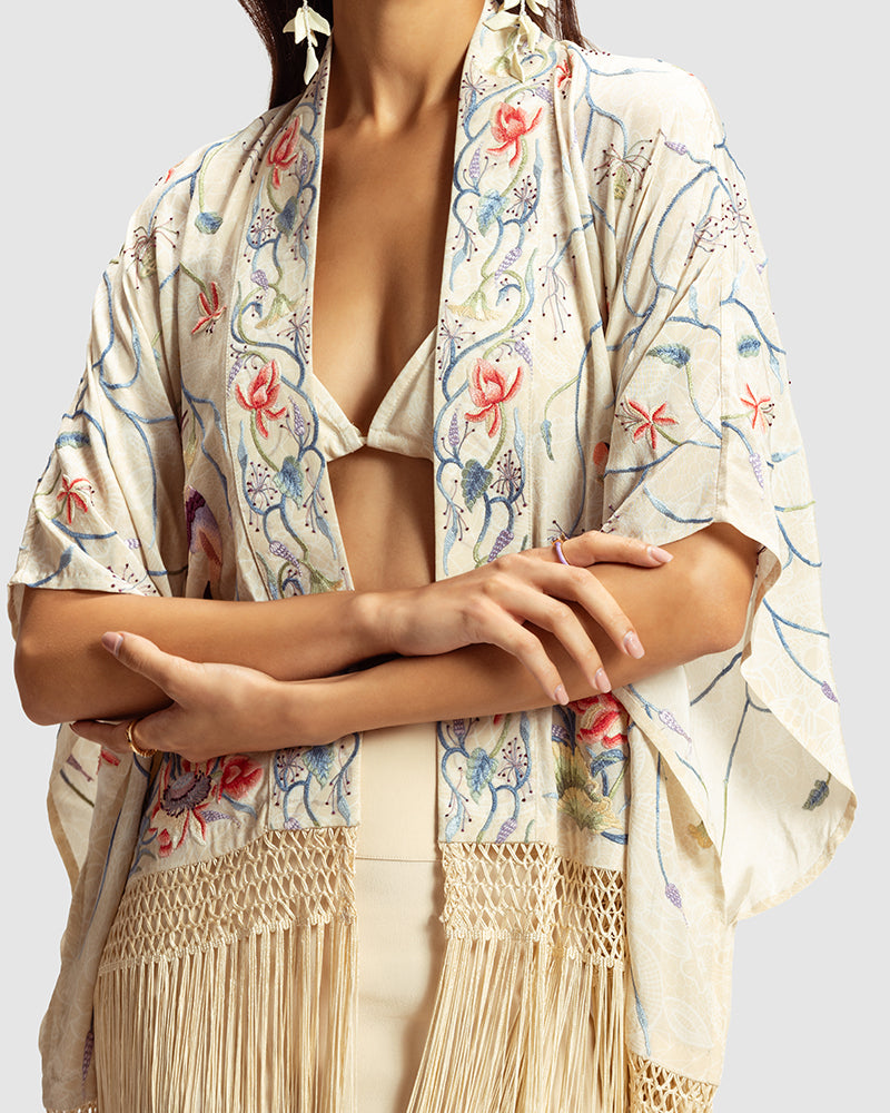 Ivory Parsi Gara Embroidered ShrugProduct DescriptionTraditionally seen on Parsi saris, this luxurious silk crepe shrug is adorned with multicoloured Parsi Gara hand embroidery. It also features a geShrugsIvory Parsi Gara Embroidered Shrug