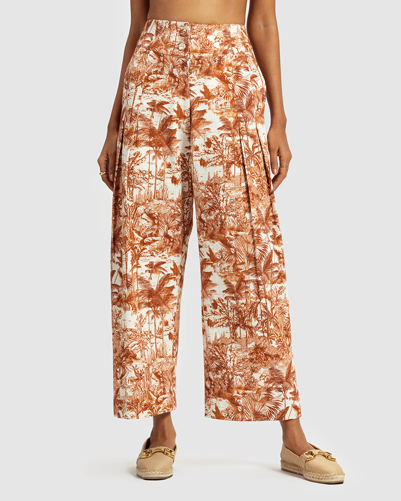 Brown Tropical Print Cotton Twill PantProduct DescriptionMade from cotton twill, these high-waisted pleated pants feature our statement tropical print that reimagines Indian flora and fauna motifs with cPantsBrown Tropical Print Cotton Twill Pant