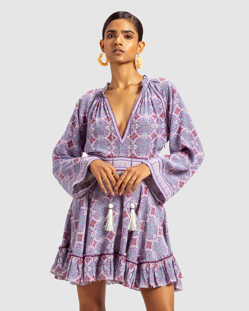 Lavender Marissa Print Ruffled Silk DressProduct DescriptionThis print patchwork ruffled dress is a mix of fit and flare, making it a perfect summer dress. It features a V-shaped neckline, a tasselled drawsDressesLavender Marissa Print Ruffled Silk Dress
