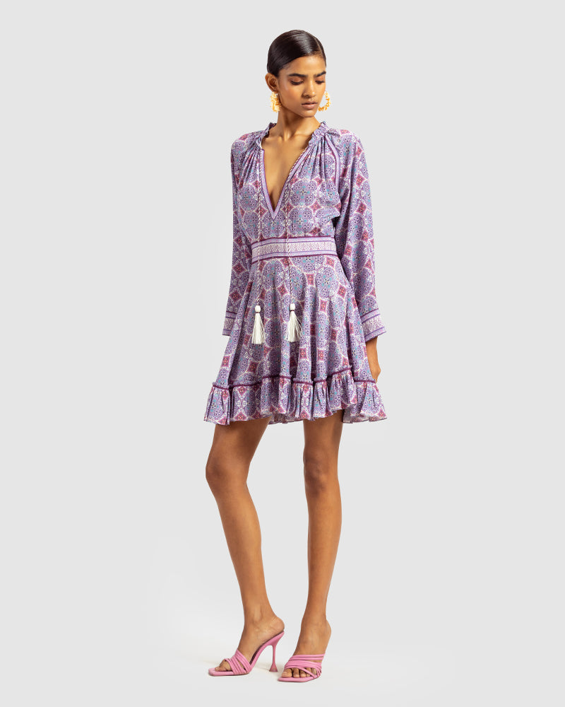 Lavender Marissa Print Ruffled Silk DressProduct DescriptionThis print patchwork ruffled dress is a mix of fit and flare, making it a perfect summer dress. It features a V-shaped neckline, a tasselled drawsDressesLavender Marissa Print Ruffled Silk Dress
