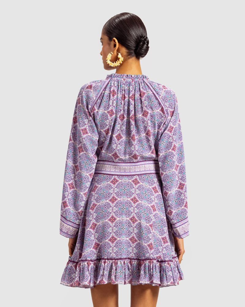 Lavender Marissa Print Ruffled Silk DressProduct DescriptionThis print patchwork ruffled dress is a mix of fit and flare, making it a perfect summer dress. It features a V-shaped neckline, a tasselled drawsDressesLavender Marissa Print Ruffled Silk Dress