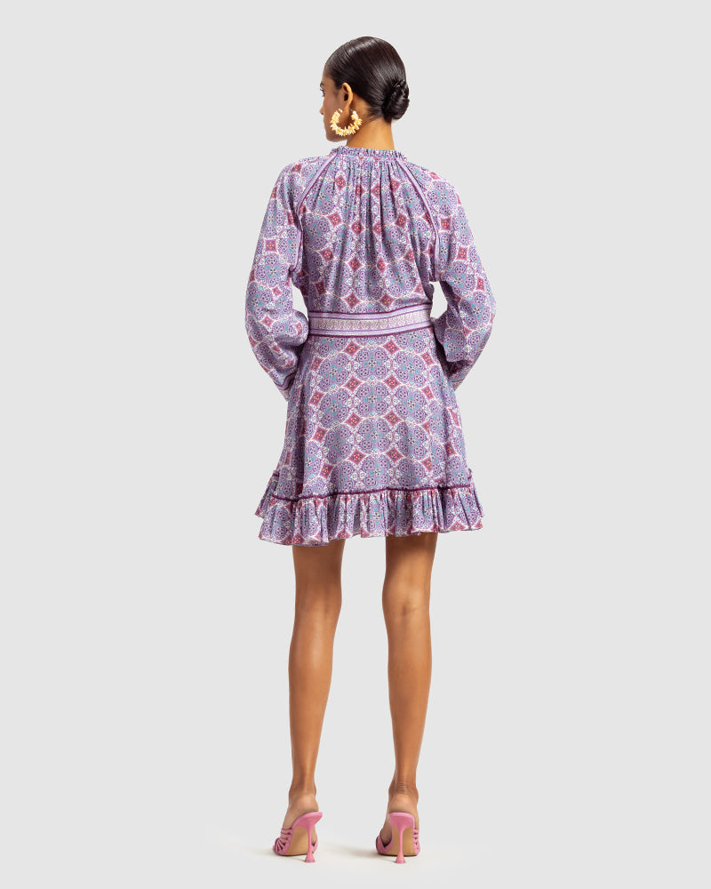 Lavender Marissa Print Ruffled Silk DressProduct DescriptionThis print patchwork ruffled dress is a mix of fit and flare, making it a perfect summer dress. It features a V-shaped neckline, a tasselled drawsDressesLavender Marissa Print Ruffled Silk Dress
