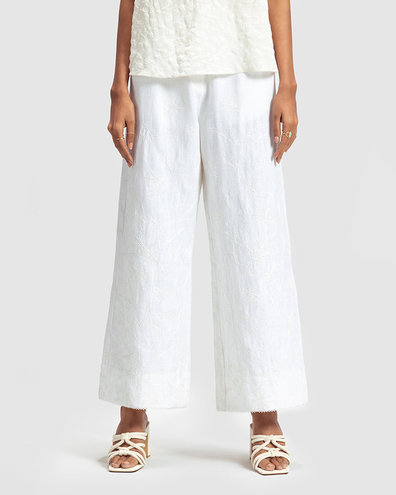 White Linen Palazzo Pant With Dori EmbroideryProduct DescriptionOur flared linen palazzo includes Dori embroidery all over and a delicate touch of lace at the hem. It also features a hook-and-eye zipper closurePantsWhite Linen Palazzo Pant