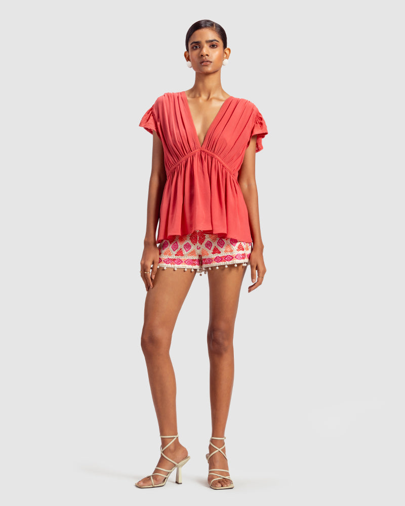 Coral Gathered Silk Georgette TopProduct DescriptionMade from 100% silk georgette, this top features hand-guided machine embroidery inspired by floral motifs. Details include a V-shaped neckline, smTopsCoral Gathered Silk Georgette Top