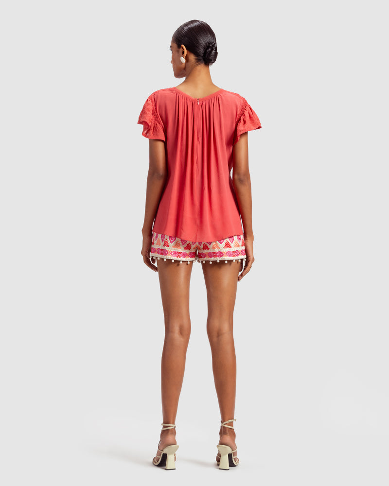 Coral Gathered Silk Georgette TopProduct DescriptionMade from 100% silk georgette, this top features hand-guided machine embroidery inspired by floral motifs. Details include a V-shaped neckline, smTopsCoral Gathered Silk Georgette Top