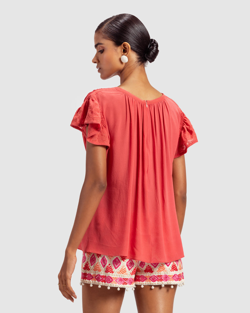 Coral Gathered Silk Georgette TopProduct DescriptionMade from 100% silk georgette, this top features hand-guided machine embroidery inspired by floral motifs. Details include a V-shaped neckline, smTopsCoral Gathered Silk Georgette Top