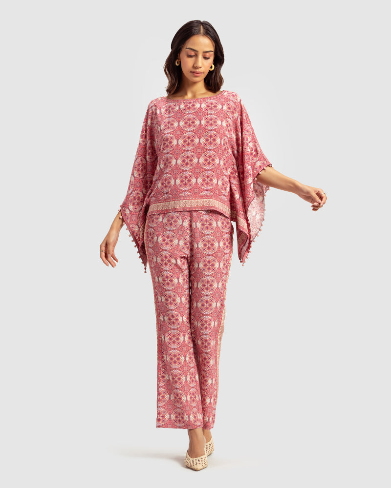Pink Marissa Print Silk Poncho TopProduct DescriptionMade from silk crepe, this boatneck poncho top features our modern geometric print patchwork. Comes in a relaxed fit and also features bobble trimTopsPink Marissa Print Silk Poncho Top