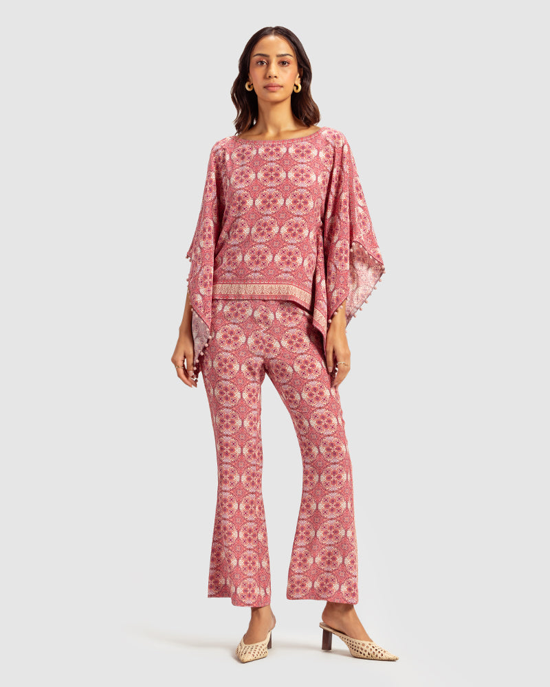 Pink Marissa Print Silk Poncho TopProduct DescriptionMade from silk crepe, this boatneck poncho top features our modern geometric print patchwork. Comes in a relaxed fit and also features bobble trimTopsPink Marissa Print Silk Poncho Top