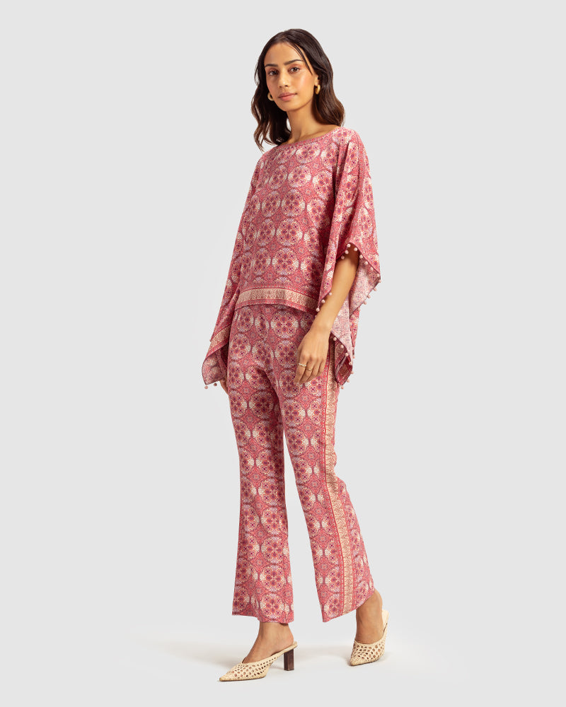 Pink Marissa Print Silk Poncho TopProduct DescriptionMade from silk crepe, this boatneck poncho top features our modern geometric print patchwork. Comes in a relaxed fit and also features bobble trimTopsPink Marissa Print Silk Poncho Top
