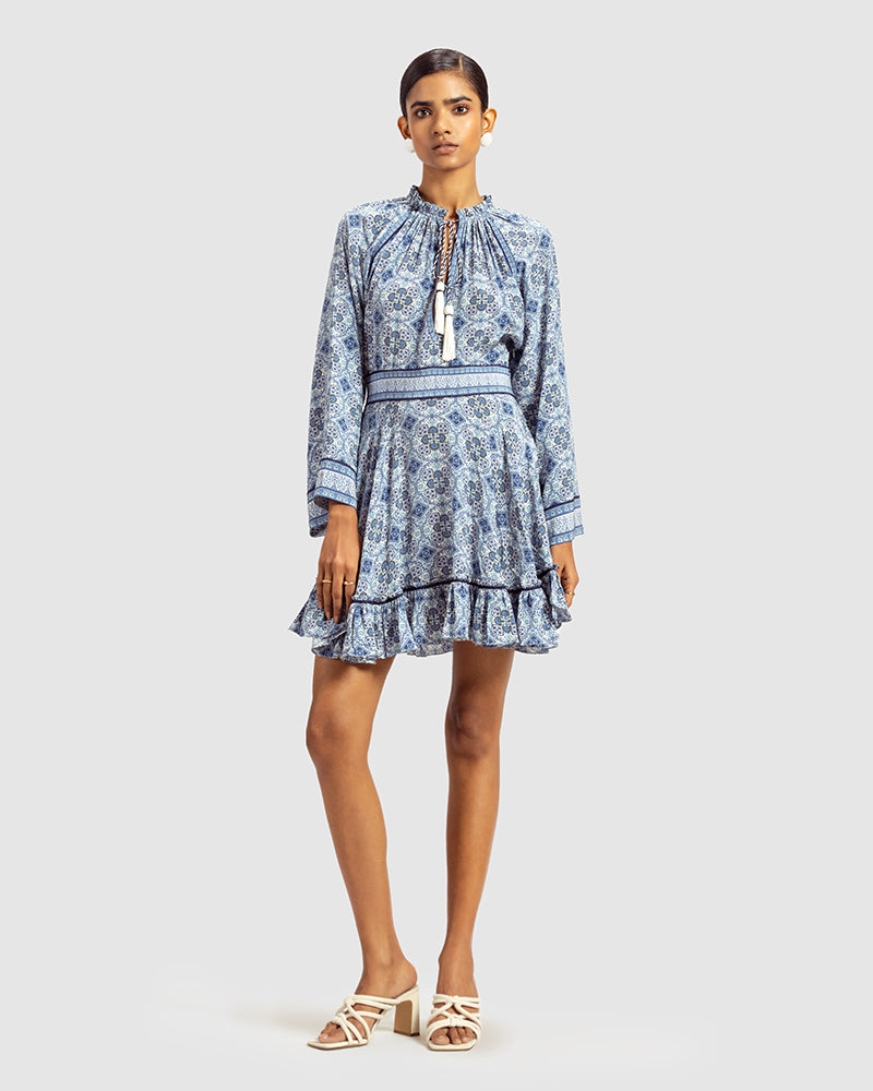 Blue Marissa Print Ruffled Silk DressProduct DescriptionThis print patchwork ruffled dress is a mix of fit and flare, making it a perfect summer dress. It features a V-shaped neckline, a tasselled drawsDressesBlue Marissa Print Ruffled Silk Dress