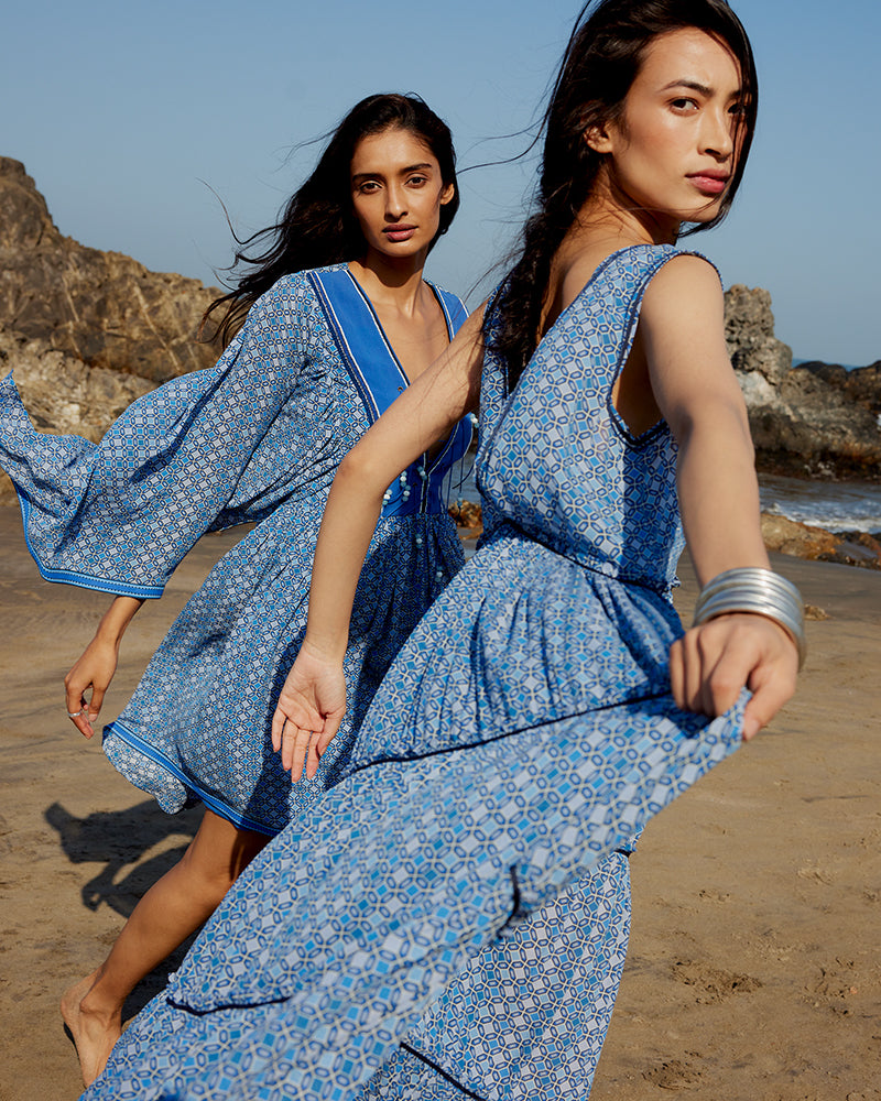 Blue Geo Print Gathered Silk DressProduct DescriptionWith print patchwork inspired by folk geometric patterns, this gathered dress is how we’ve reimagined Talitha’s signature bohemian language. Made DressesBlue Geo Print Gathered Silk Dress