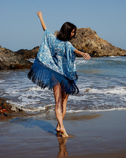 Blue Gara Embroidered Tropical Print ShrugProduct DescriptionMade from silk satin, this statement shrug is enveloped in a blend of tropical print and tonal Gara embroidery. Also features a generous silk frinShrugsBlue Gara Embroidered Tropical Print Shrug