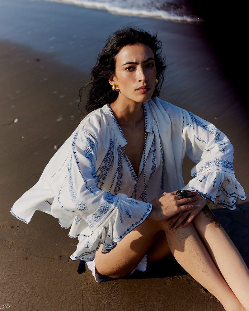 Blue on White Embroidered Linen Blend Boho TopProduct DescriptionThis linen blend boho top features an eclectic blend of blue-on-white lace and embroidery with Kolam-inspired motifs. Comes in an oversized relaxeTopsWhite Embroidered Linen Blend Boho Top