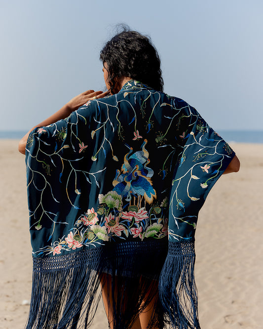 Navy Parsi Gara Embroidered ShrugProduct DescriptionTraditionally seen on Parsi saris, this luxurious silk crepe shrug is adorned with multicoloured Parsi Gara hand embroidery. It also features a geShrugsNavy Parsi Gara Embroidered Shrug