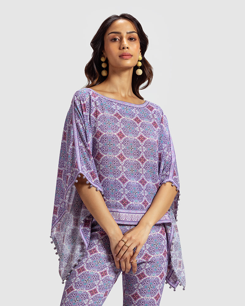 Lavender Marissa Print Silk Poncho TopProduct DescriptionMade from silk crepe, this boatneck poncho top features our modern geometric print patchwork. Comes in a relaxed fit and also features bobble trimTopsLavender Marissa Print Silk Poncho Top