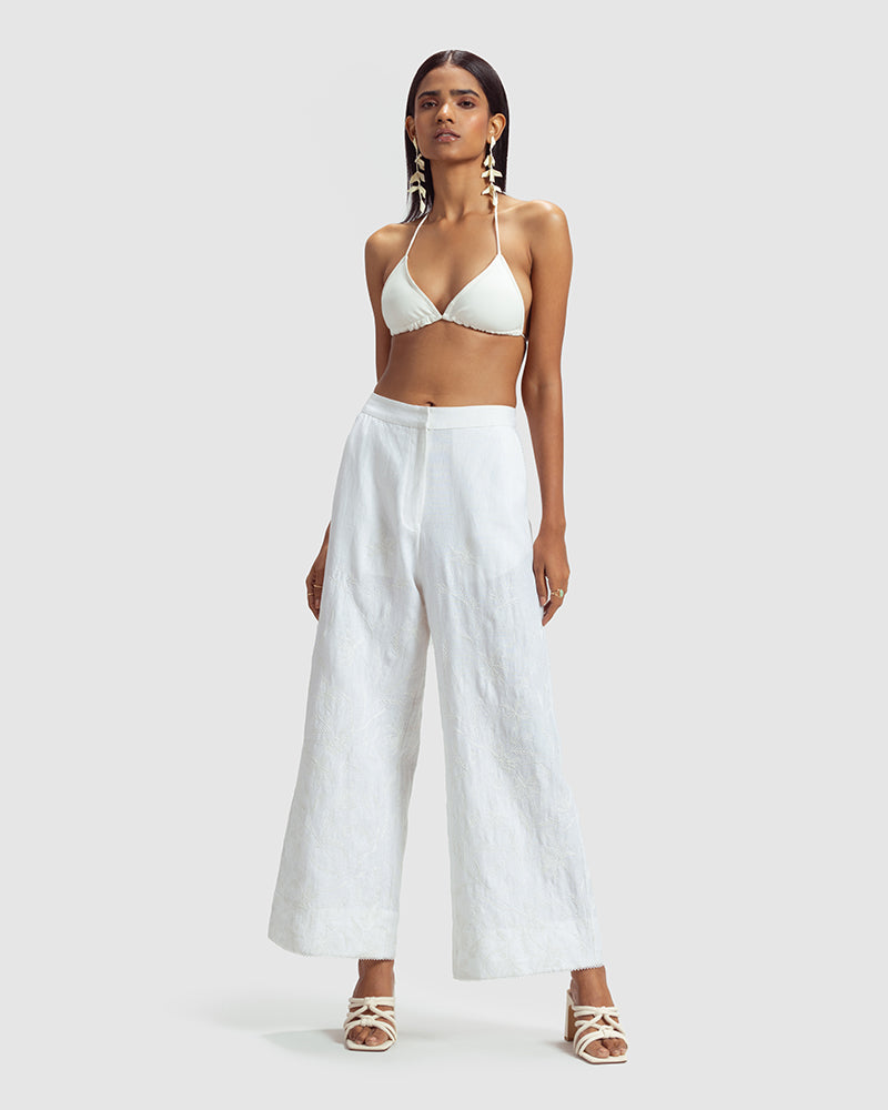 White Linen Palazzo Pant With Dori EmbroideryProduct DescriptionOur flared linen palazzo includes Dori embroidery all over and a delicate touch of lace at the hem. It also features a hook-and-eye zipper closurePantsWhite Linen Palazzo Pant