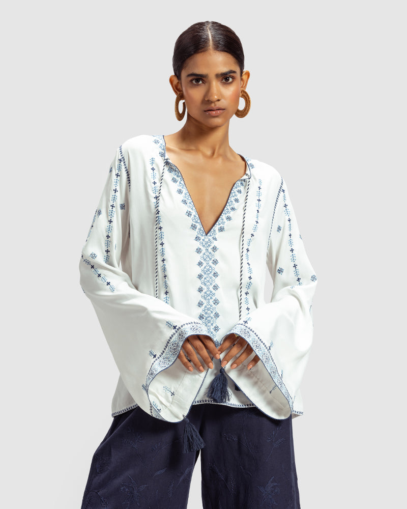 Blue on White Embroidered Satin Blend TopProduct DescriptionThis relaxed-fit top is adorned with Kolam-inspired motif embroidery, and also features tassels on the front-neck drawstring and sleeve hems. 
FroWhite Embroidered Satin Blend Top