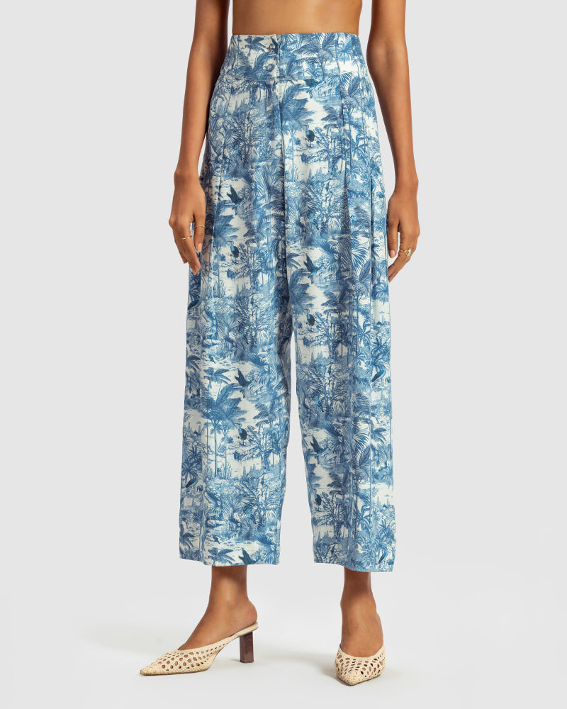Blue Tropical Print Silk Pleated PantProduct DescriptionMade from silk satin, these high-waisted pleated pants feature our statement tropical print that reimagines Indian flora and fauna motifs with conPantsBlue Tropical Print Silk Pleated Pant