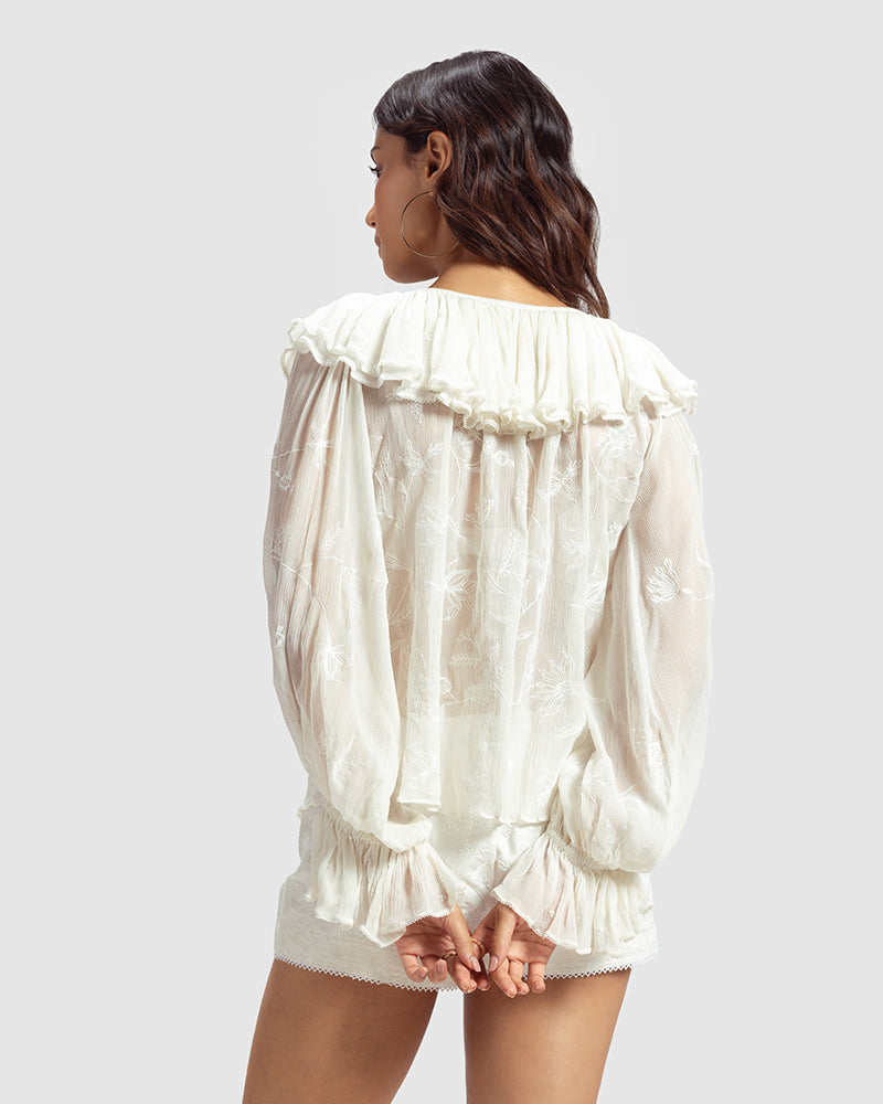 White Ruffled Silk Blouse With Dori EmbroideryProduct DescriptionThis statement crinkled silk chiffon blouse features Dori embroidery and floral motifs inspired by Mughal architecture. Details include elasticateTopsWhite Ruffled Silk Blouse