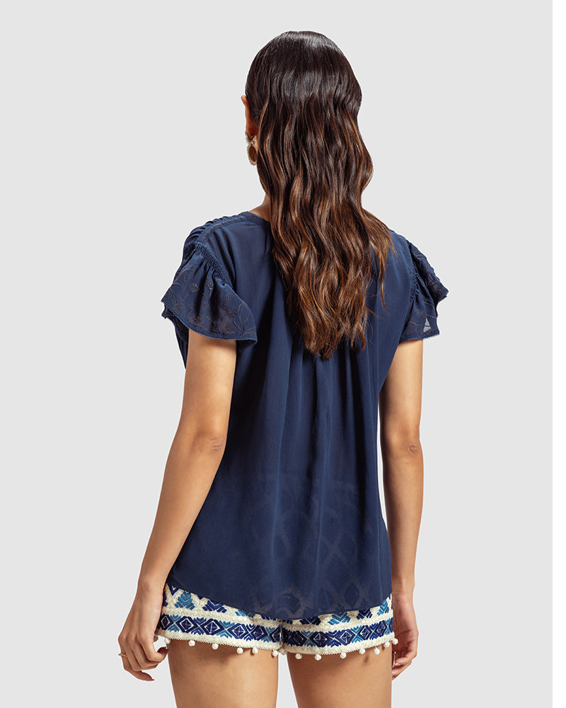 Blue Gathered Silk Georgette TopProduct DescriptionMade from 100% silk georgette, this top features hand-guided machine embroidery inspired by floral motifs. Details include a V-shaped neckline, smTopsBlue Gathered Silk Georgette Top