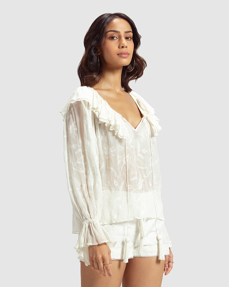 White Ruffled Silk Blouse With Dori EmbroideryProduct DescriptionThis statement crinkled silk chiffon blouse features Dori embroidery and floral motifs inspired by Mughal architecture. Details include elasticateTopsWhite Ruffled Silk Blouse