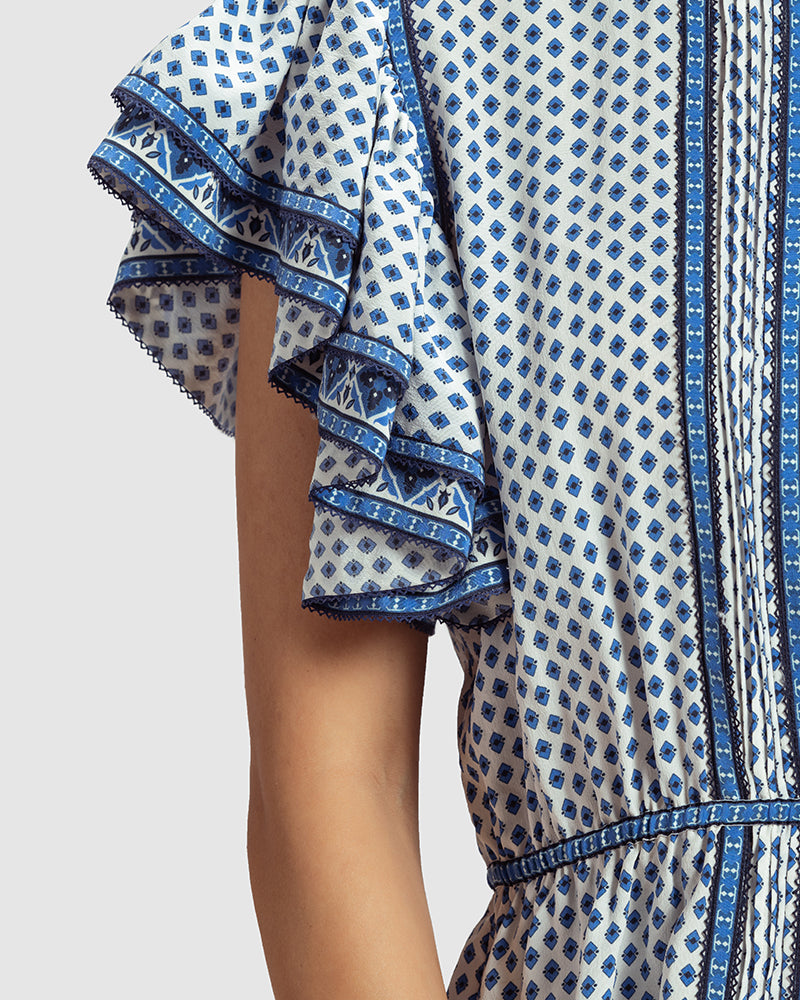 Tara Print Silk Crepe Anaya TopProduct DescriptionThis silk crepe top is enveloped in our contemporary blue print inspired by folk geometric patterns. Details include ruffled sleeves, lace trimminTopsTara Print Silk Crepe Anaya Top