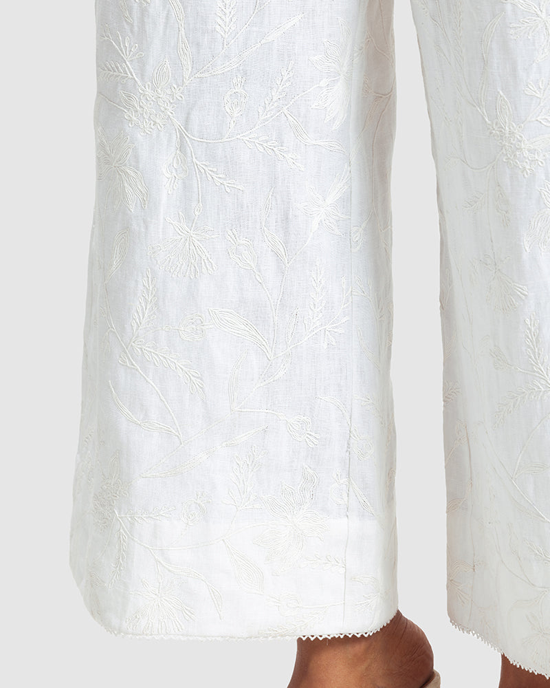 White Linen Palazzo Pant With Dori EmbroideryProduct DescriptionOur flared linen palazzo includes Dori embroidery all over and a delicate touch of lace at the hem. It also features a hook-and-eye zipper closurePantsWhite Linen Palazzo Pant
