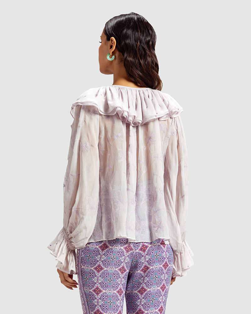 Lilac Ruffled Silk Blouse With Dori EmbroideryProduct DescriptionThis statement crinkled silk chiffon blouse features Dori embroidery and floral motifs inspired by Mughal architecture. Details include elasticateTopsLilac Ruffled Silk Blouse