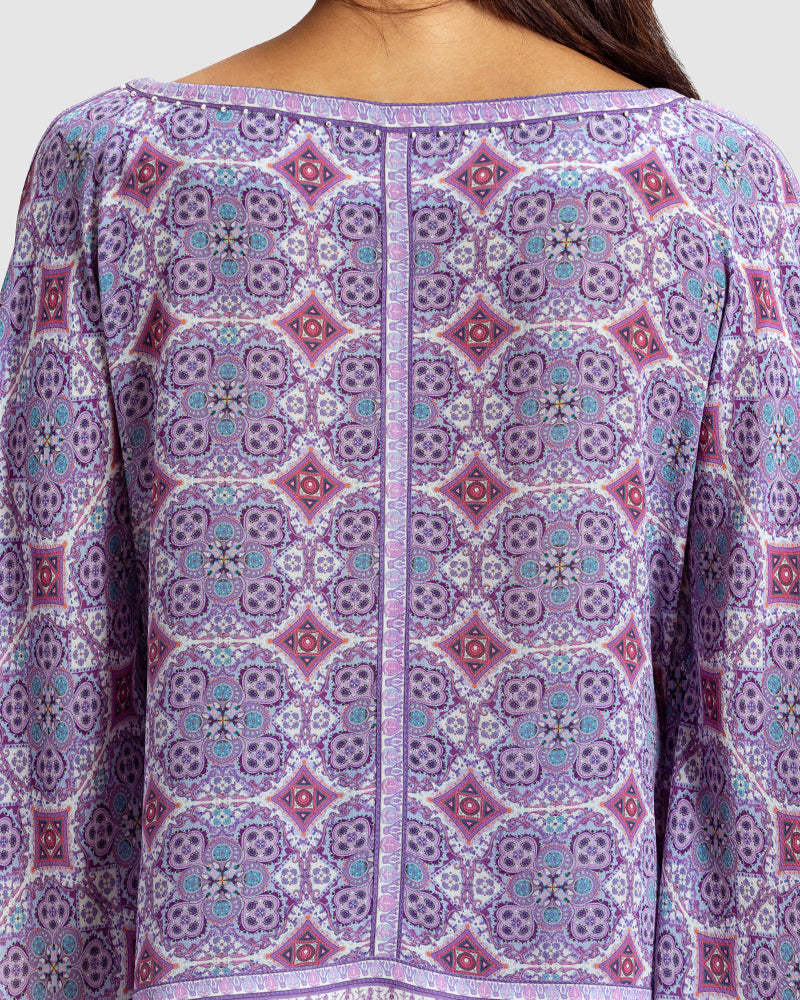 Lavender Marissa Print Silk Poncho TopProduct DescriptionMade from silk crepe, this boatneck poncho top features our modern geometric print patchwork. Comes in a relaxed fit and also features bobble trimTopsLavender Marissa Print Silk Poncho Top