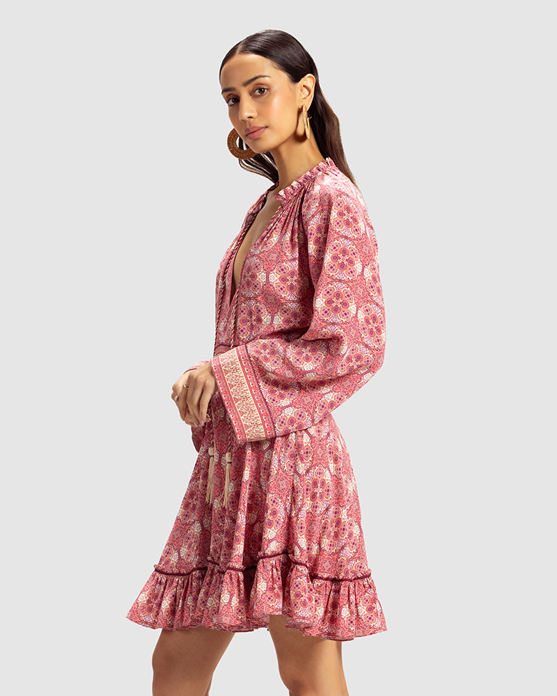 Pink Marissa Print Ruffled Silk DressProduct DescriptionThis print patchwork ruffled dress is a mix of fit and flare, making it a perfect summer dress. It features a V-shaped neckline, a tasselled drawsDressesPink Marissa Print Ruffled Silk Dress
